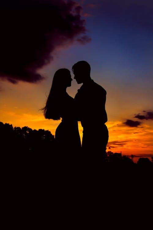 Couple embracing on a beach at sunset